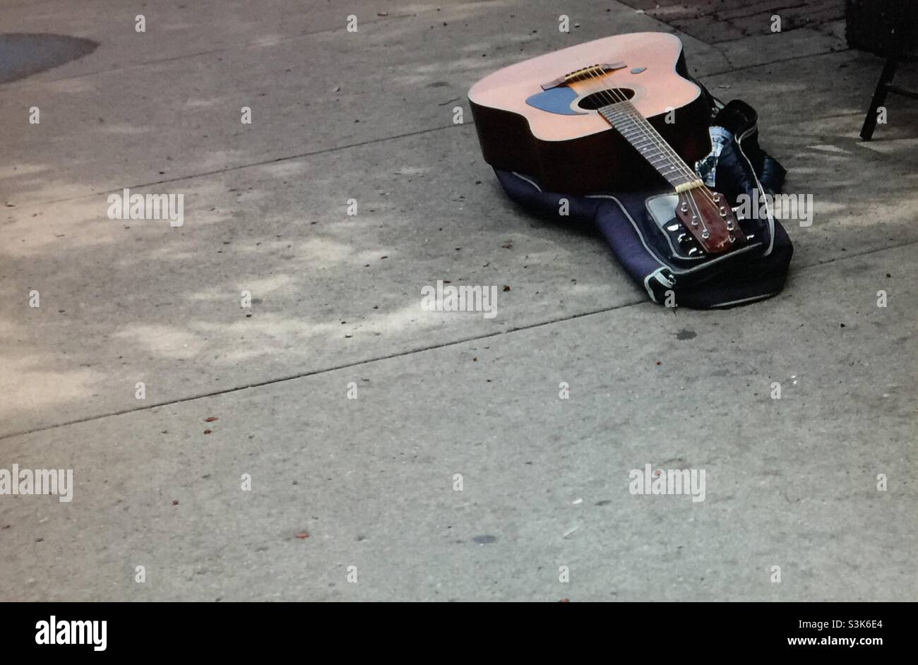 Street photography, Kensington, Calgary, Alberta , 10 street, guitar, guitar case, music, busker, street musician - Smartphone Captured Stock Image