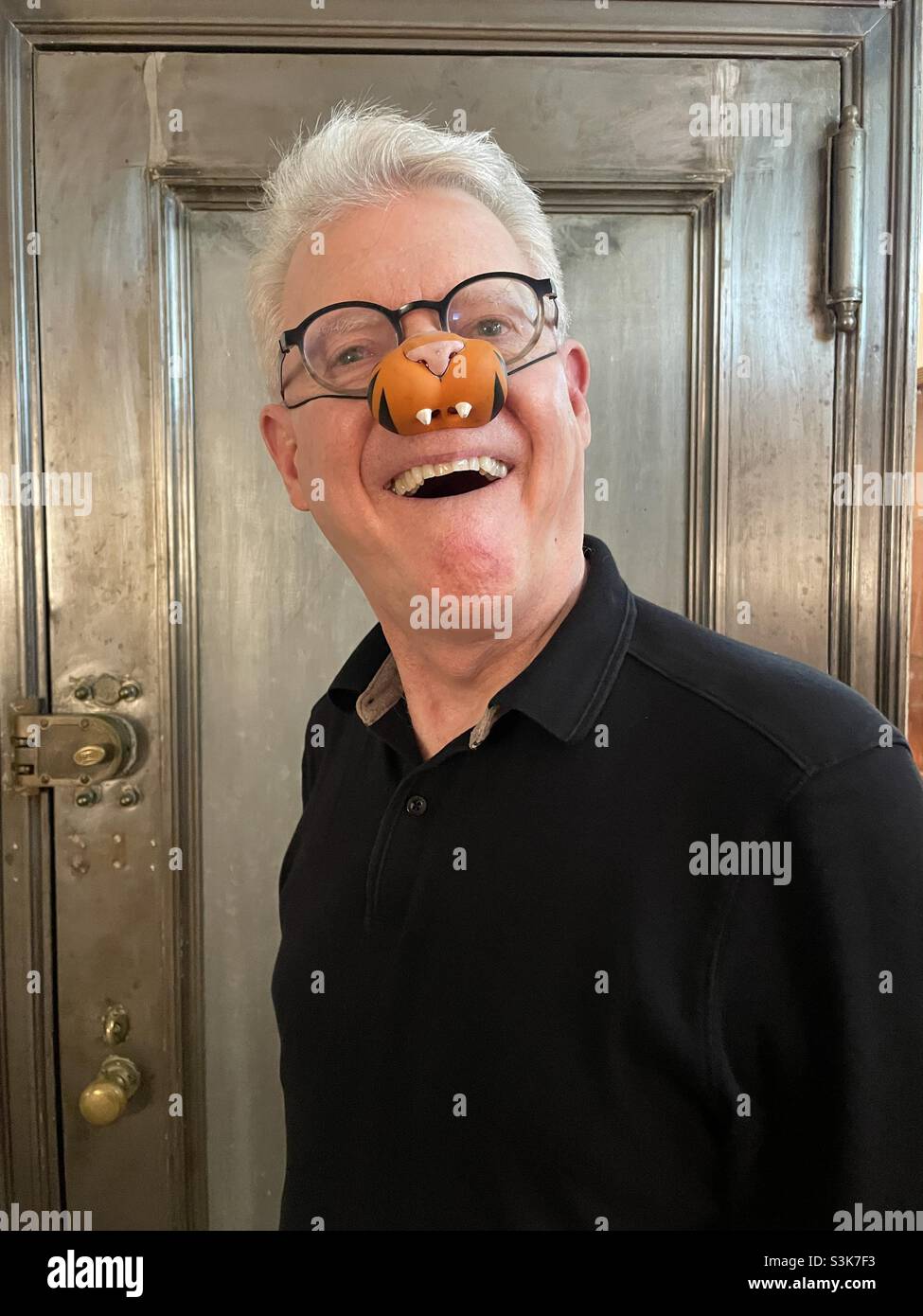Men wearing a silly tiger knows mask - Smartphone Captured Stock Image
