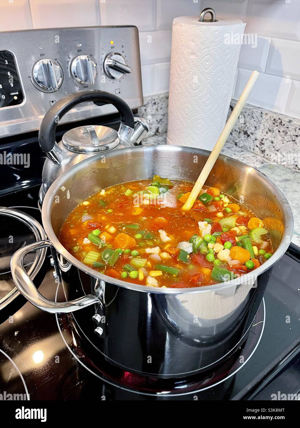 Homemade heart healthy vegetable soup cooking on a stovetop Stock Photo