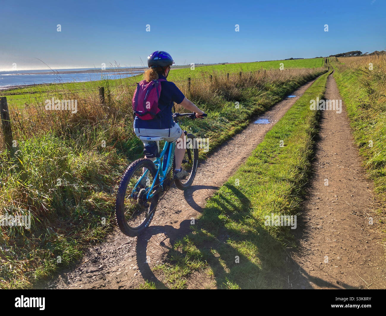 Woman cycling in Northumberland - Smartphone Captured Stock Image