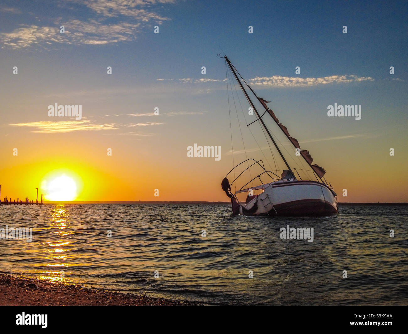 Wrecked Sailboat during sunset at Island Beach State Park, NJ Stock Photo