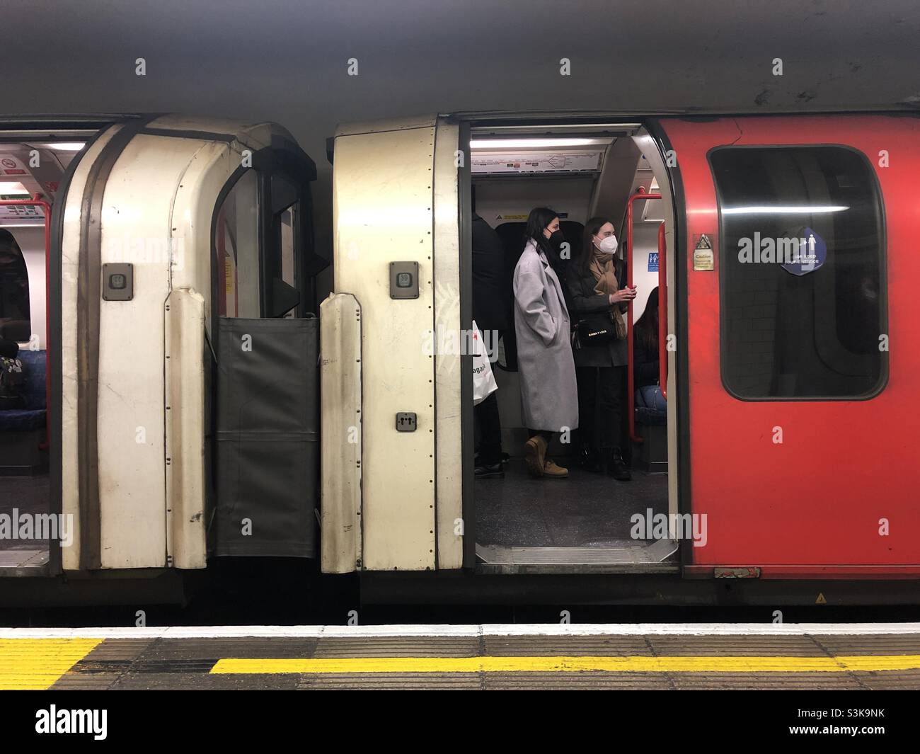 Commuters  wearing face mask on London Underground train - Smartphone Captured Stock Image
