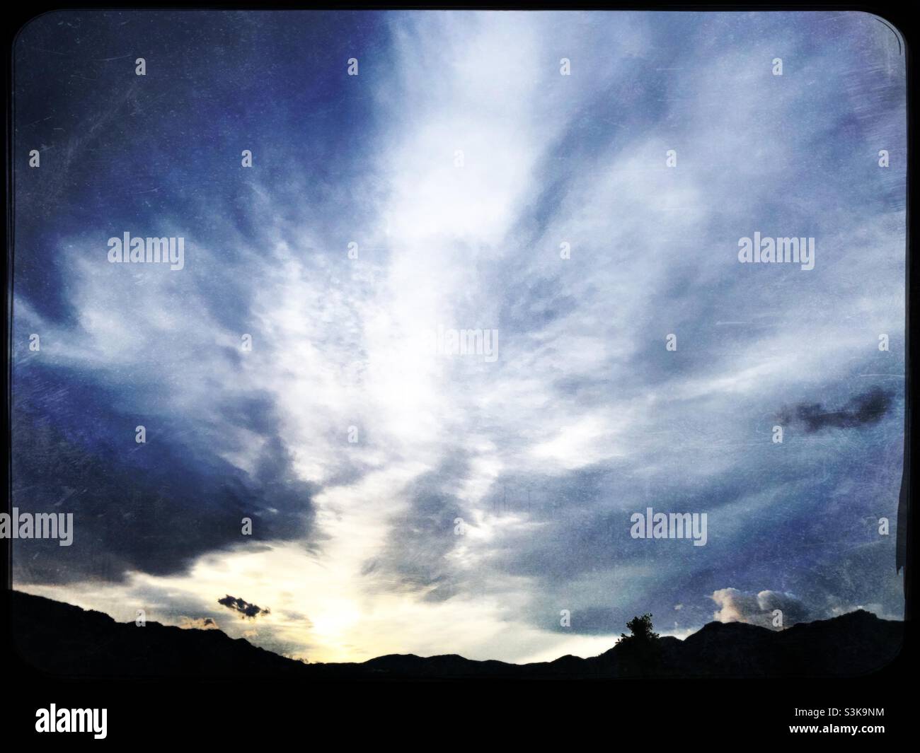 Dramatic evening sky at dusk over mountains in eastern Spain near Orba - Smartphone Captured Stock Image Dramatic evening sky at dusk over mountains in eastern Spain near Orba - Smartphone Captured Stock Image