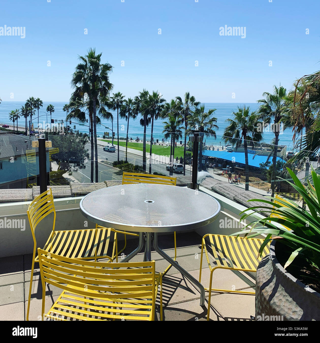 Table and chairs overlooking the beach on the rooftop deck, Springhill Suites San Diego Carlsbad, Carlsbad, San Diego County, United States, North America - Smartphone Captured Stock Image