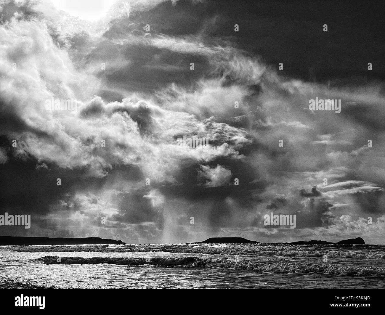 Dramatic rain clouds over Worm’s Head, Gower, Wales, October. Stock Photo