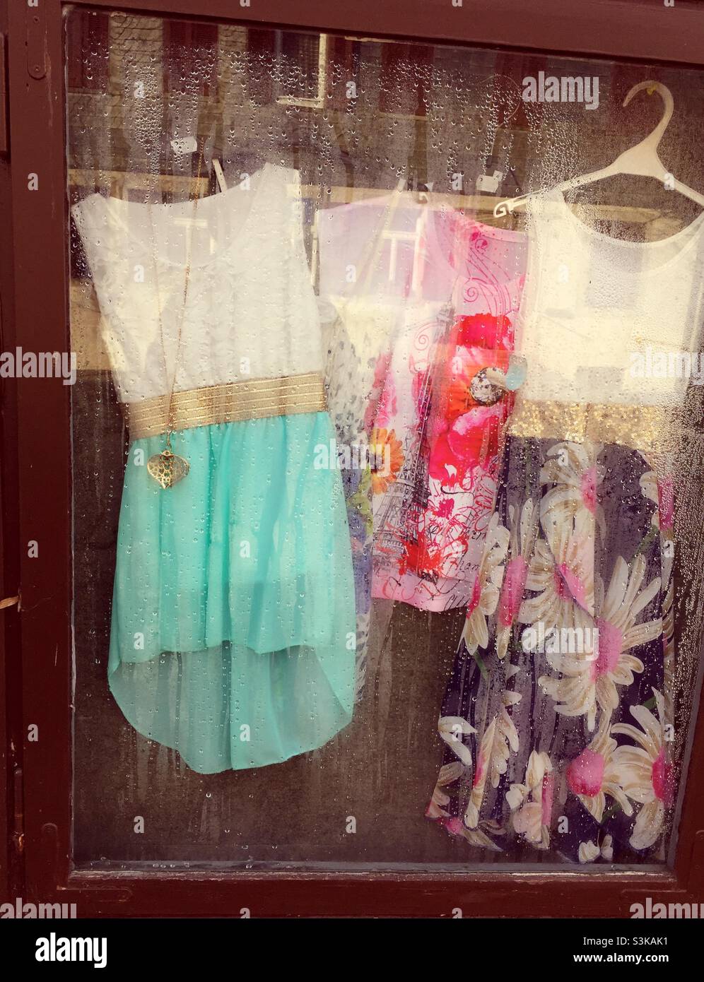 Old fashioned clothes hanging in a window - Smartphone Captured Stock Image