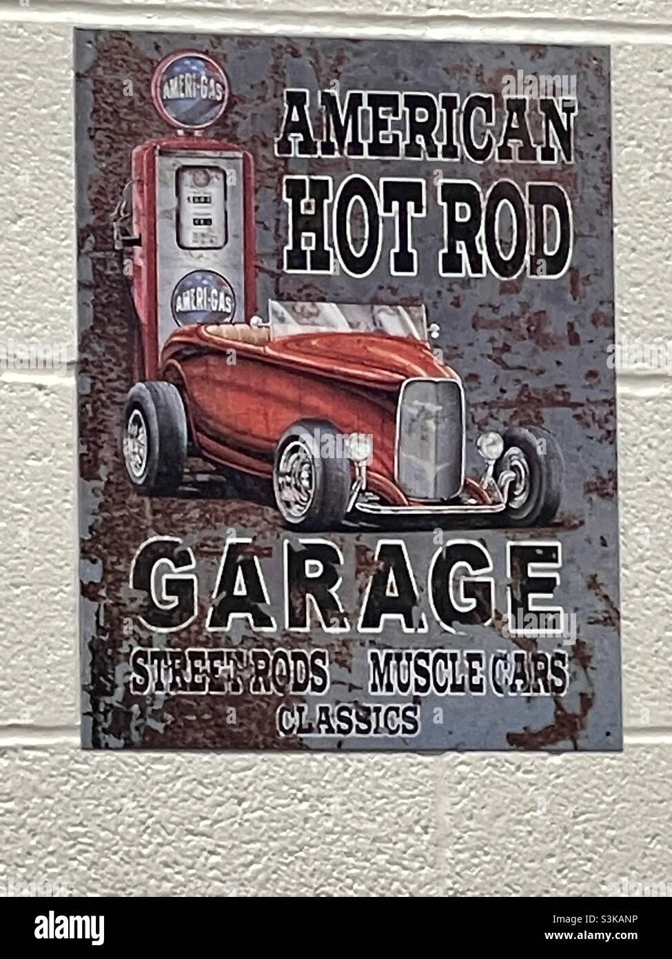 A poster, on the wall of an auto repair shop, depicting the classic American Hot Rod. - Smartphone Captured Stock Image