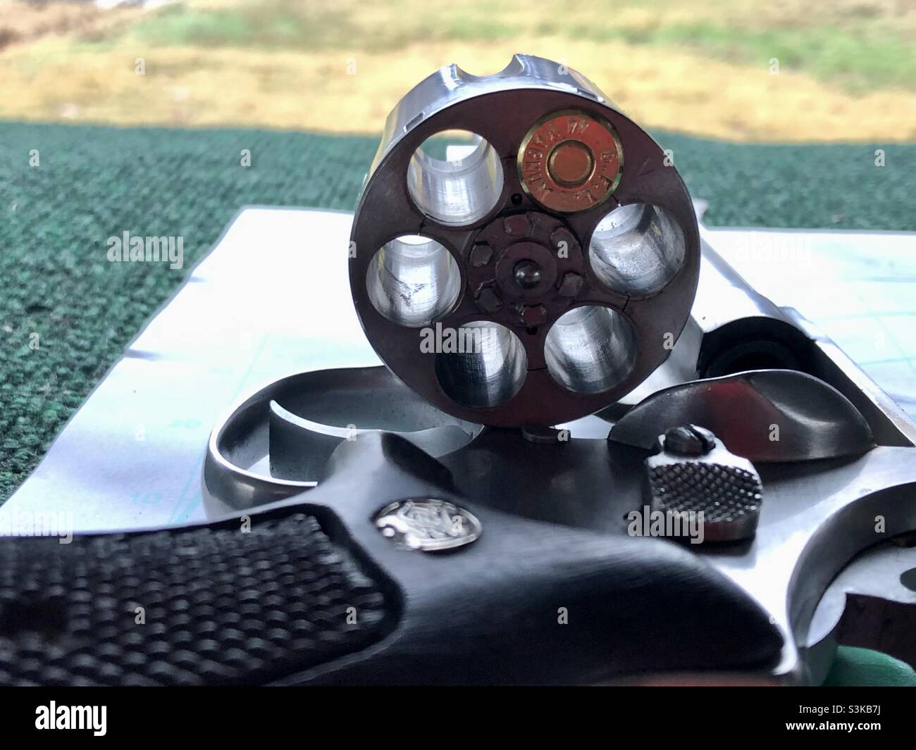 A single bullet in a Magnum revolver at a shooting range in Texas - Smartphone Captured Stock Image