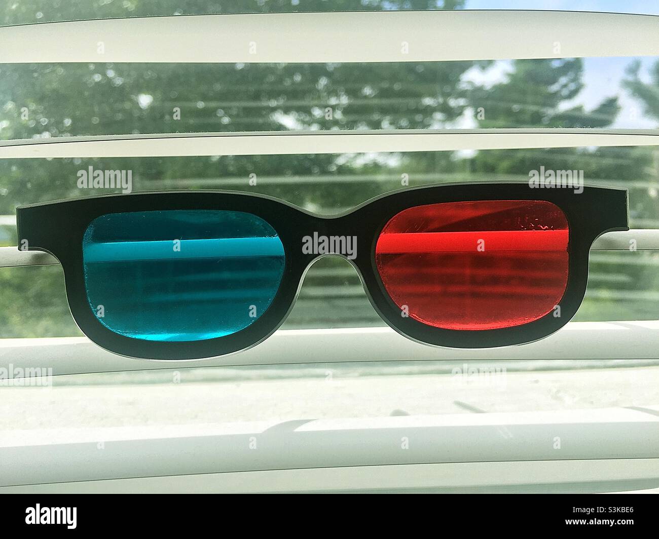 3D glasses in a window. Rose colour and blue. A surrealist view. - Smartphone Captured Stock Image