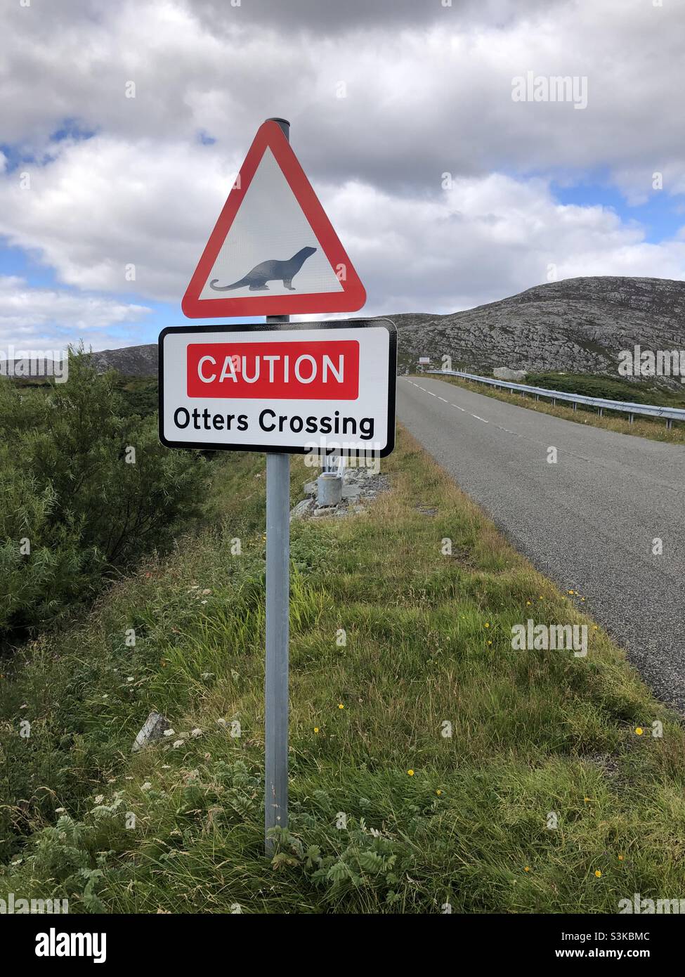 An Otters crossing road sign warns people to slow down on a road in the Outer Hebrides in Scotland Stock Photo