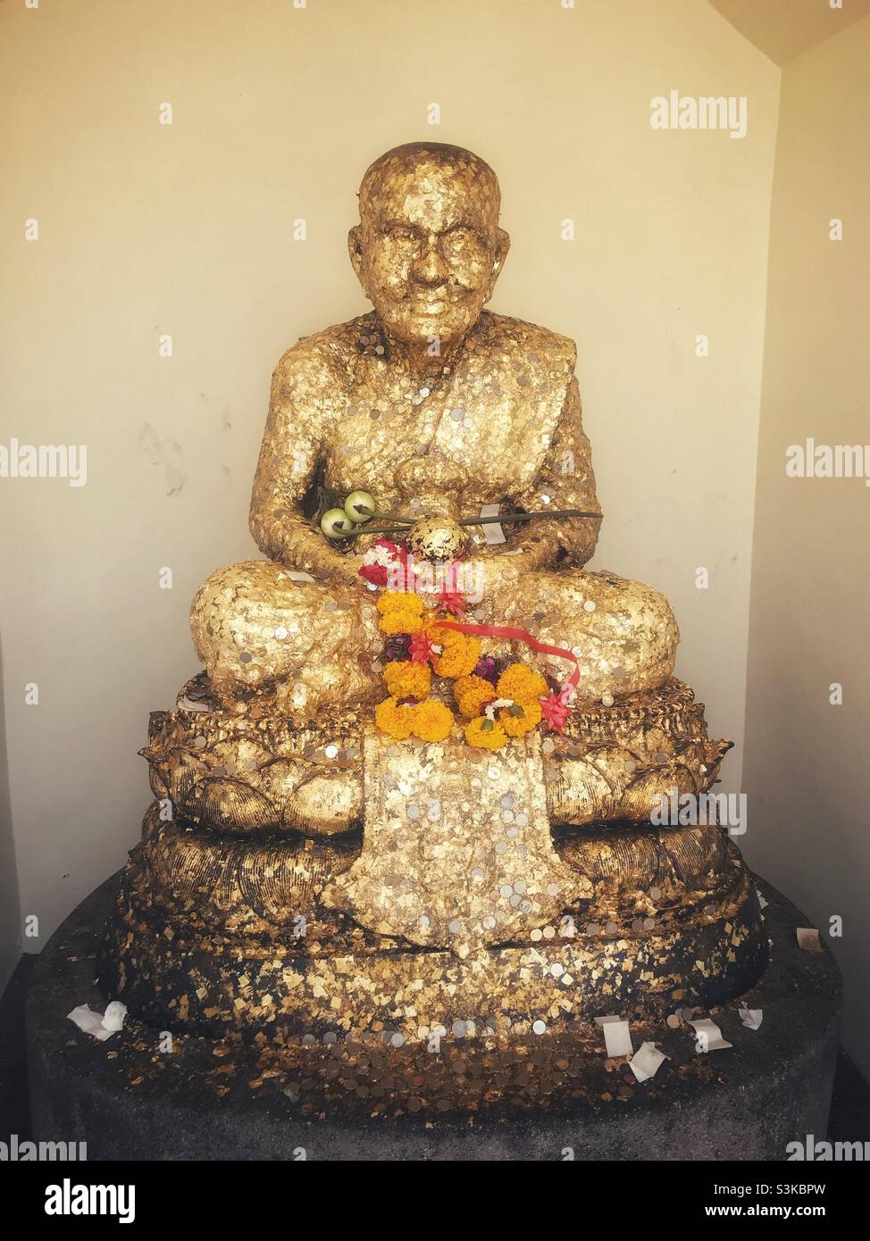 Statue of Luang Phor Thuad covered in gold leaf at Wat Huay Mongkol in Hua Hin, Thailand - Smartphone Captured Stock Image