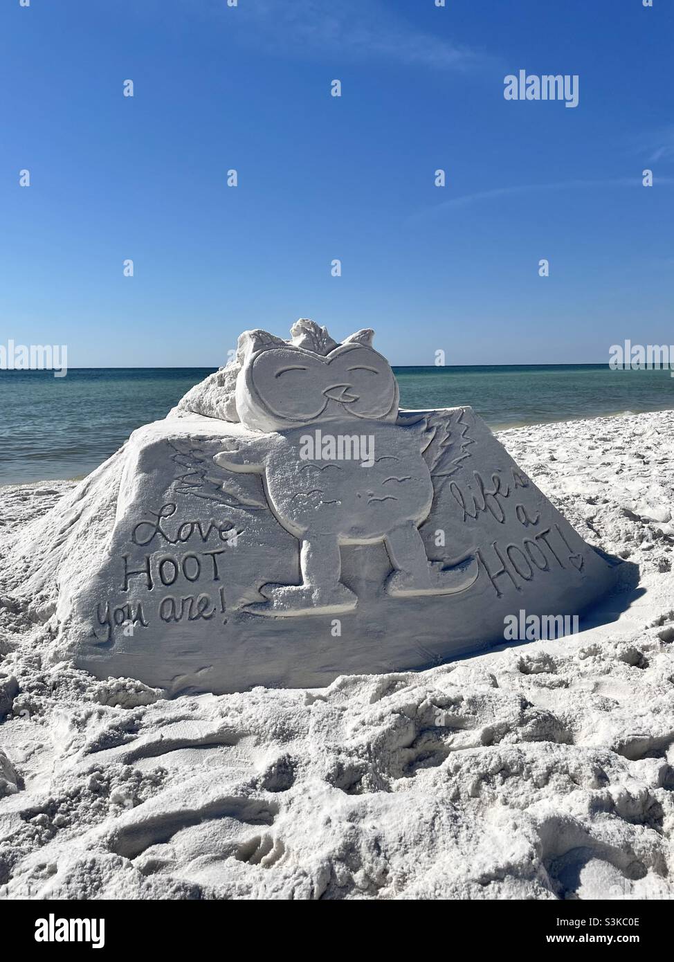 Sandcastle on white sand beach of an owl with cute life messages - Smartphone Captured Stock Image