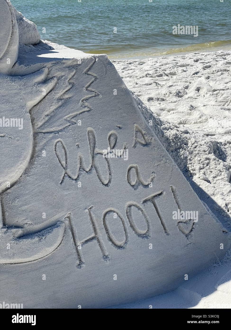 Words life’s a hoot on white sandcastle Stock Photo