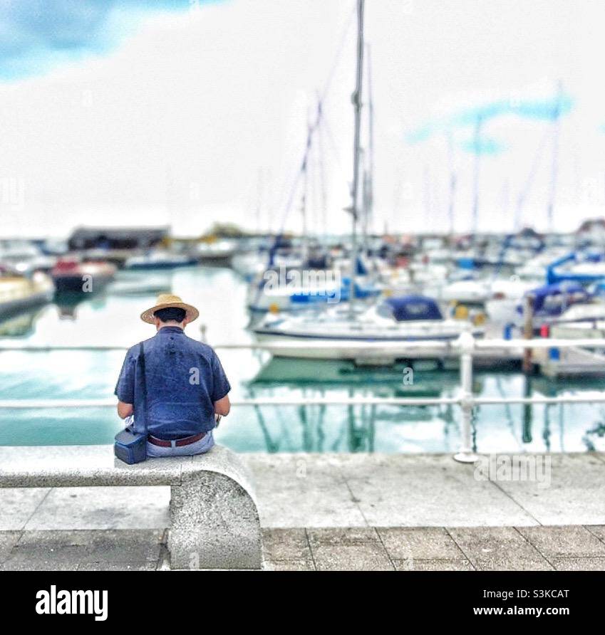 A man wearing a hat at Ramsgate Marina. - Smartphone Captured Stock Image