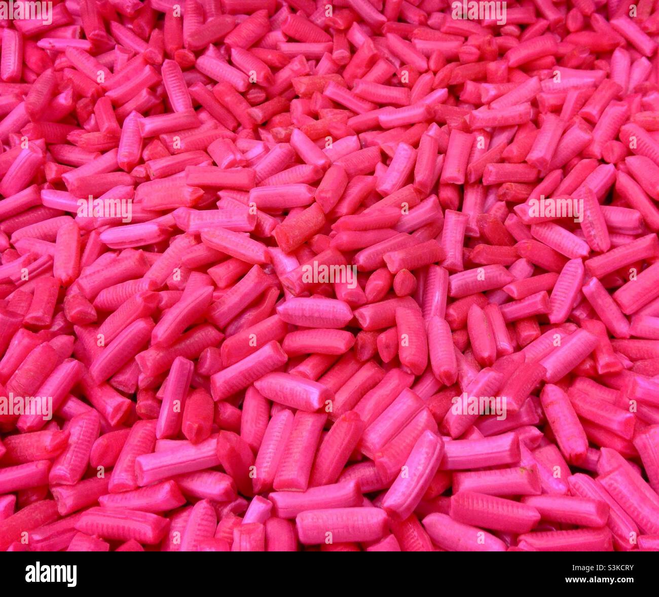 Bulk pink candy 'chicken bones' sold by the grams or ounces Stock Photo