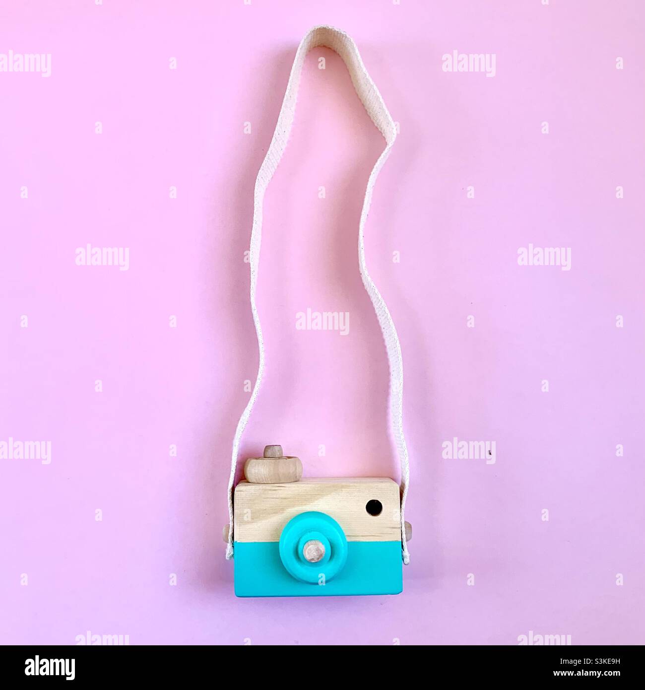 Toy photo camera on pink background Stock Photo
