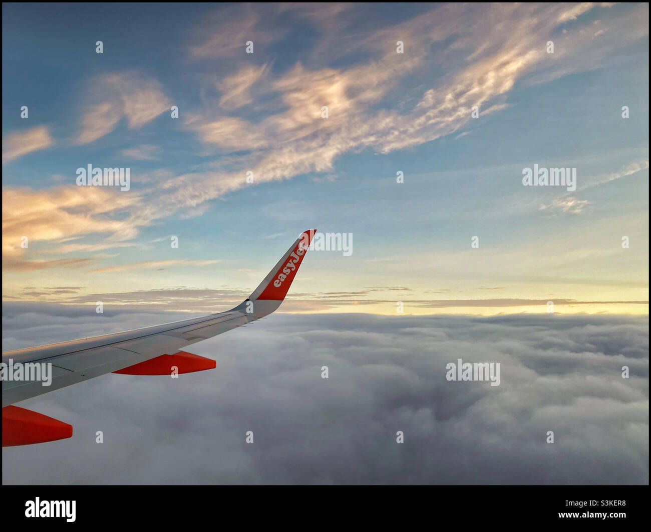 The view from row 23. It’s good to be flying again! An easyJet flight somewhere above Wales. Photo ©️ COLIN HOSKINS. - Smartphone Captured Stock Image