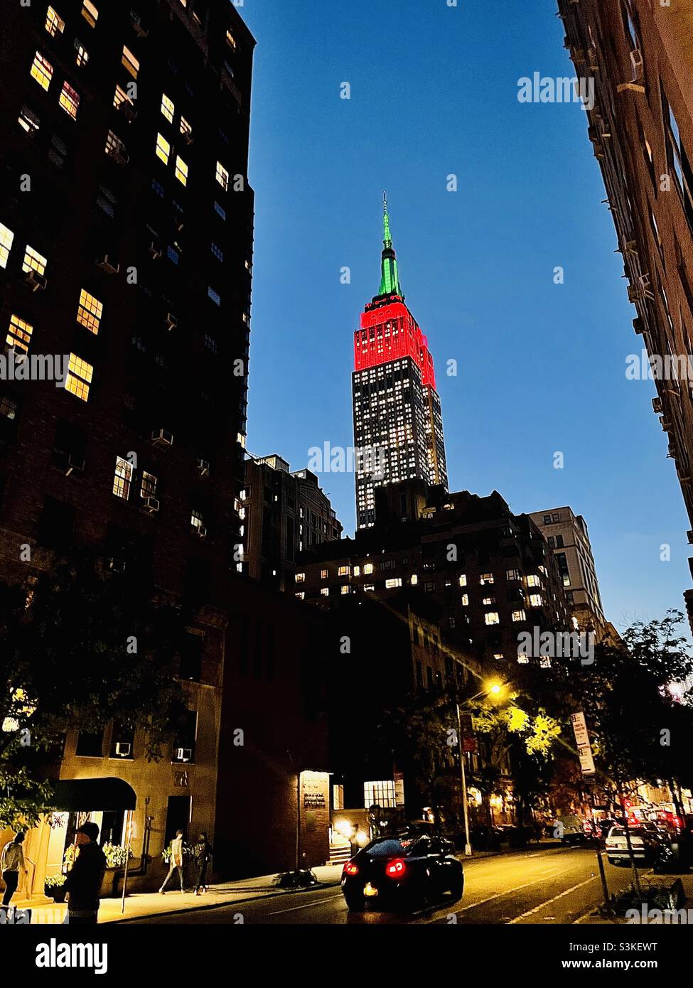 Tower Lights in red & green In Honor of the Opening Night of the 2021 Christmas Spectacular Starring the Radio City Rockettes in New York City - Smartphone Captured Stock Image