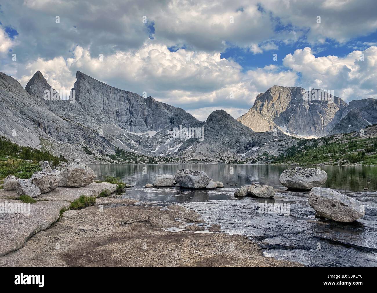 Alpine lake and view of east temple peak in Bridger-Teton National Forest on a sunny afternoon during summer, Wyoming, USA - Smartphone Captured Stock Image