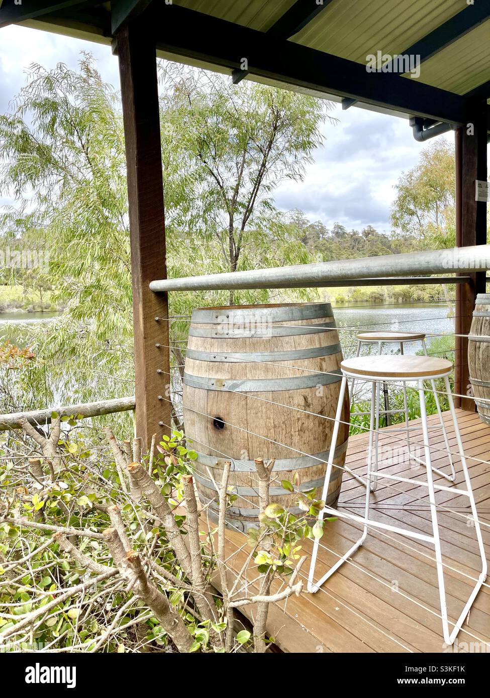 Wine barrel and stools on the verandah overlooking farm dam at Abbey Vale winery Margaret River