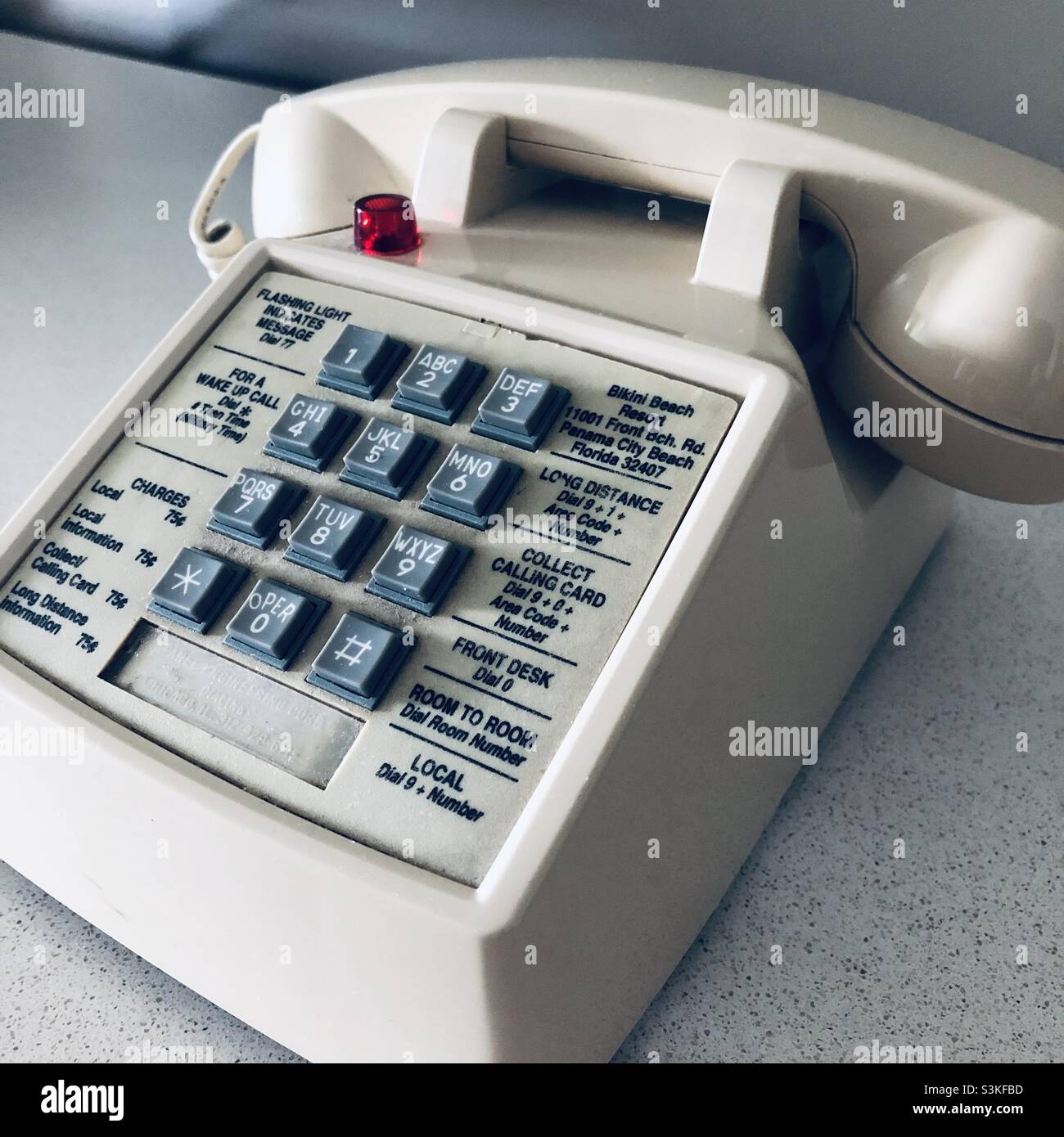 An old button telephone in a hotel room in the USA - Smartphone Captured Stock Image