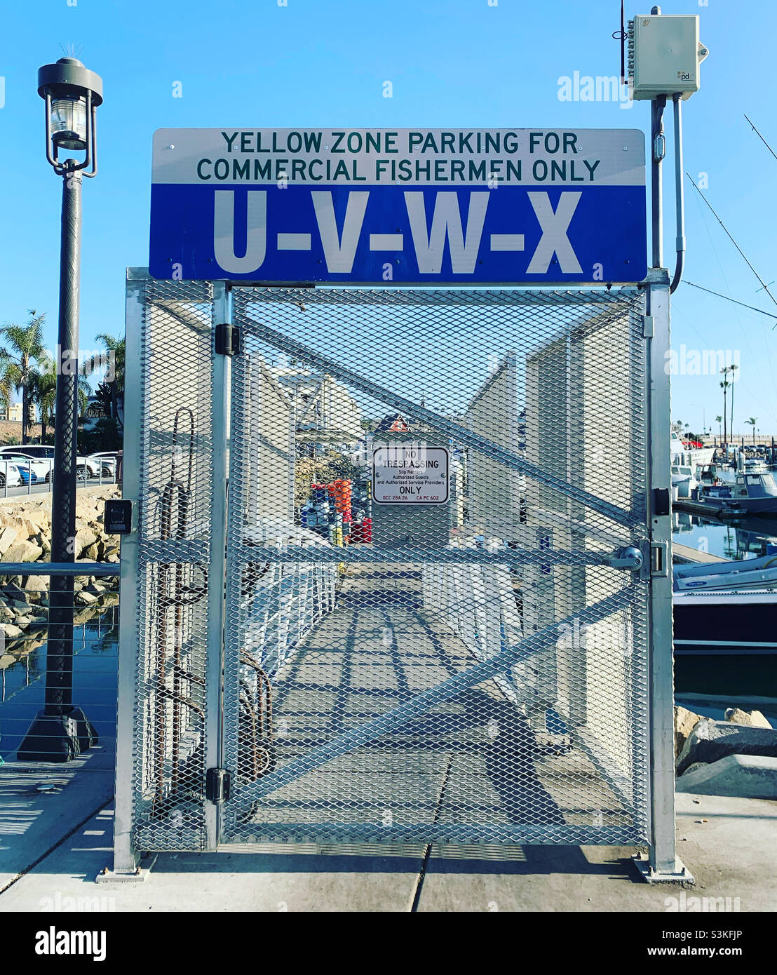 Locked area with sign “Yellow Zone Parking for Commercial Fishermen Only,” Oceanside Harbor, Oceanside, San Diego County, California, United States, North America - Smartphone Captured Stock Image