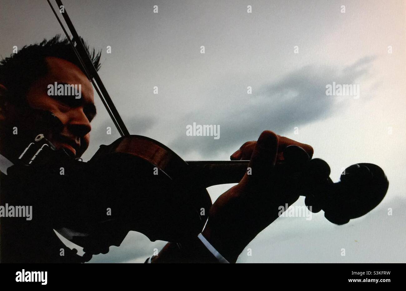Left handed fiddler silhouette - Smartphone Captured Stock Image
