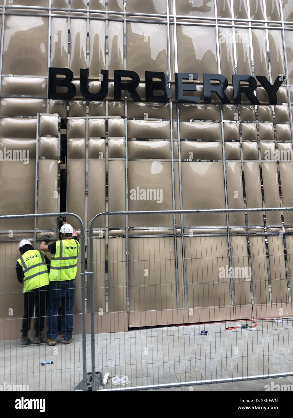 Workers In high visibility vest working for construction work for  the brand Burberry in London UK Stock Photo