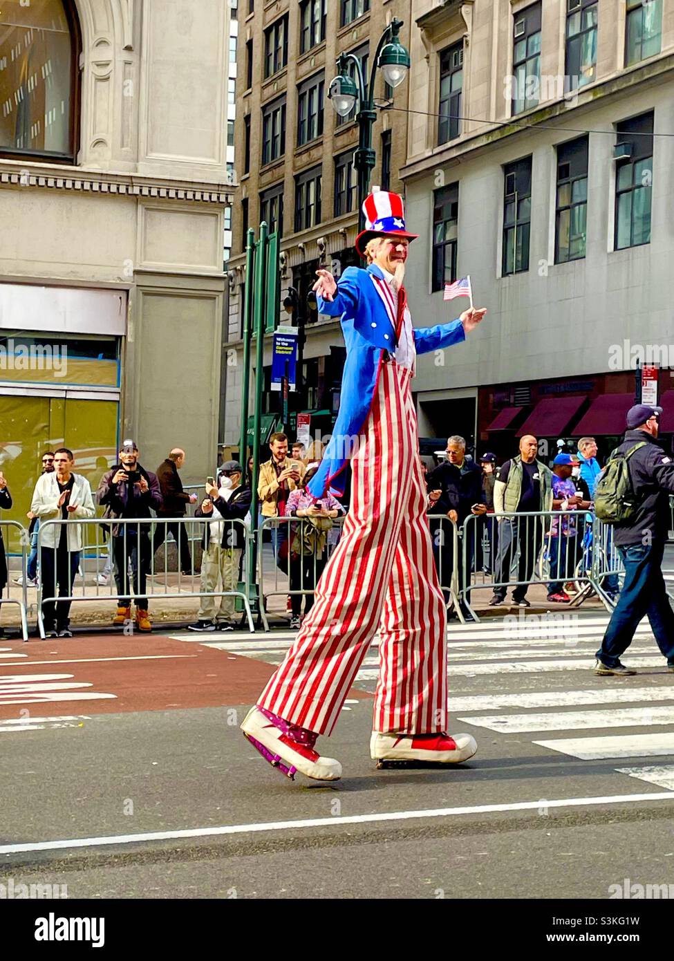 Extra tall Uncle Sam character walks in the Veterans Day parade in New York City - Smartphone Captured Stock Image