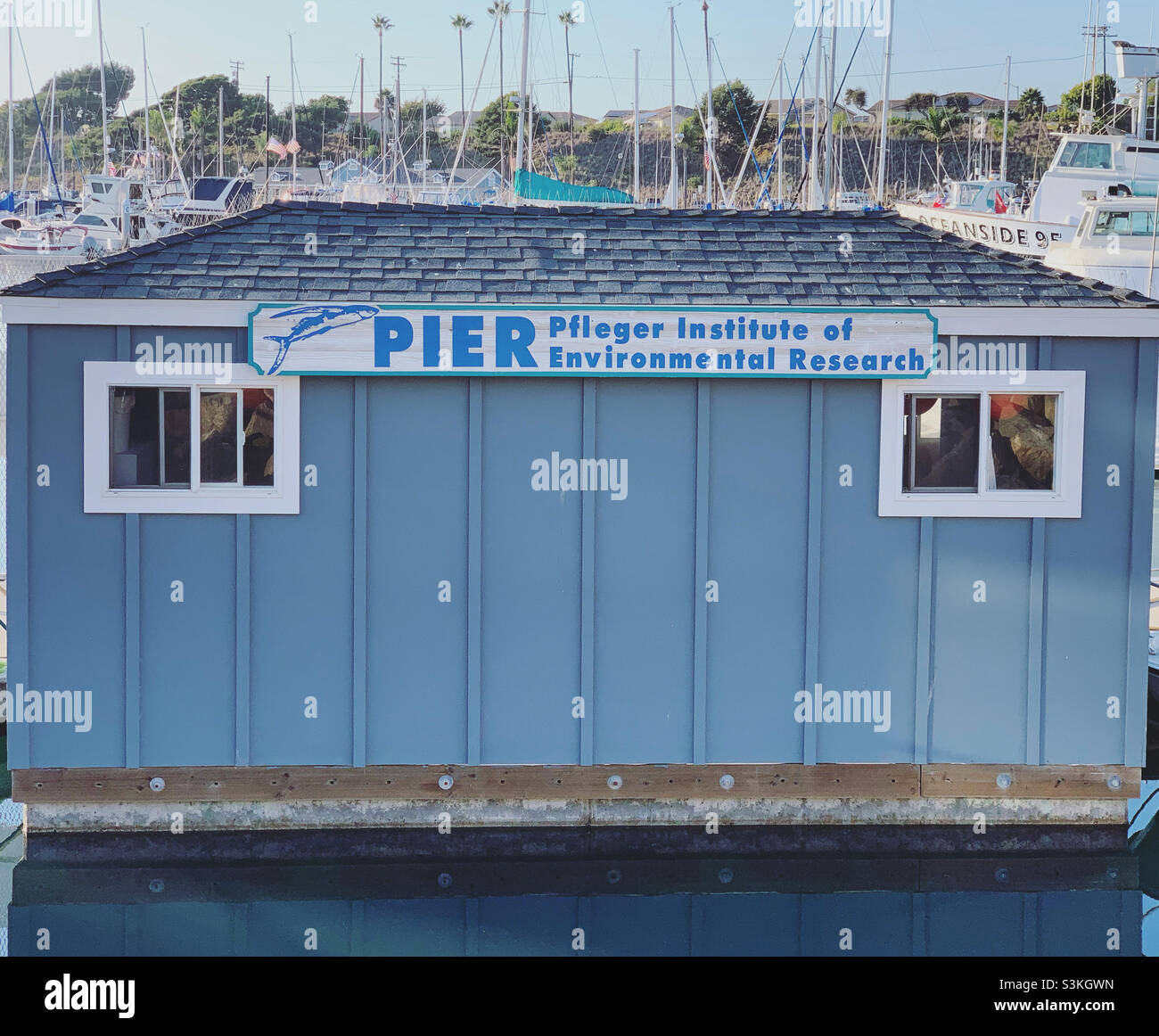 Sign on a structure reads “PIER : Pfleger Institute for Environmental Research,” Oceanside Harbor, Oceanside, San Diego County, California, United States, North America - Smartphone Captured Stock Image