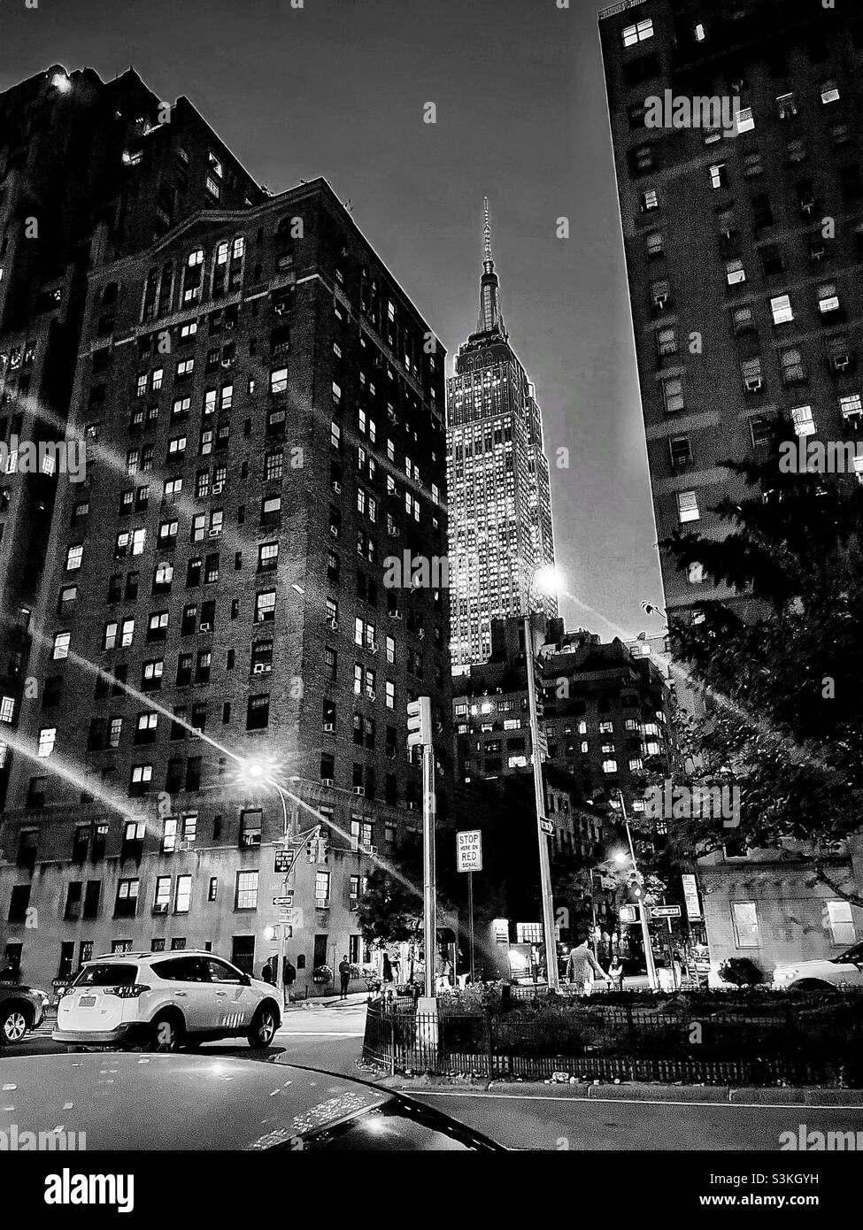 Black and white photo of a New York City intersection at night - Smartphone Captured Stock Image