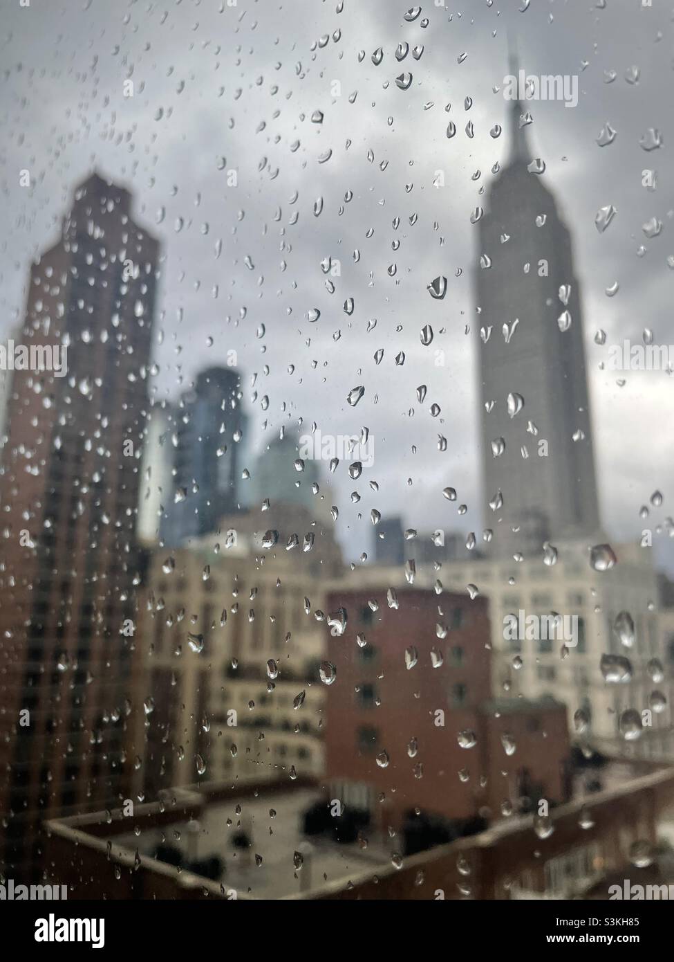 Raindrops on a window overlooking the Empire State building in New York City - Smartphone Captured Stock Image