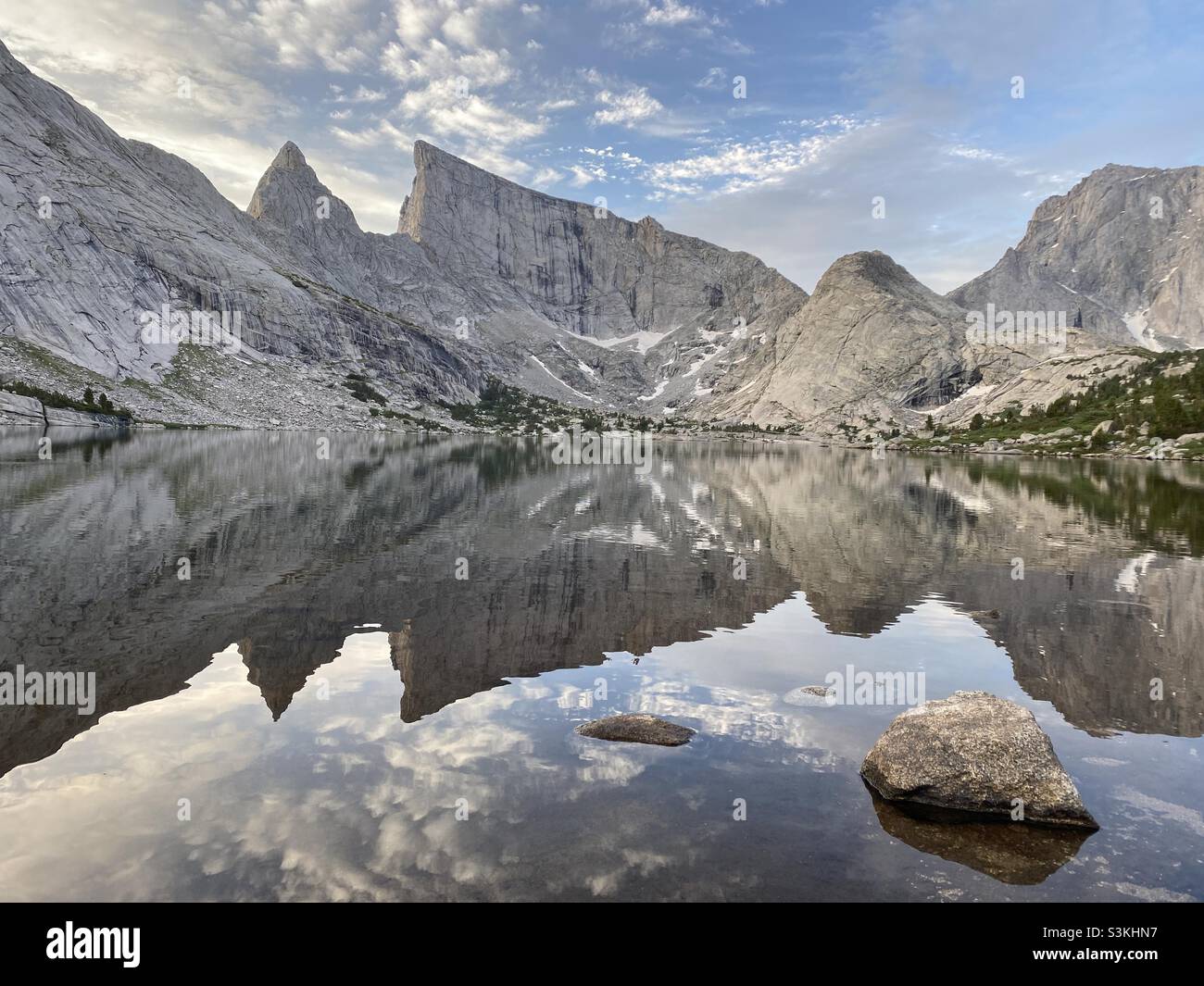 Alpine lake below East Temple Peak in early morning with a calm water