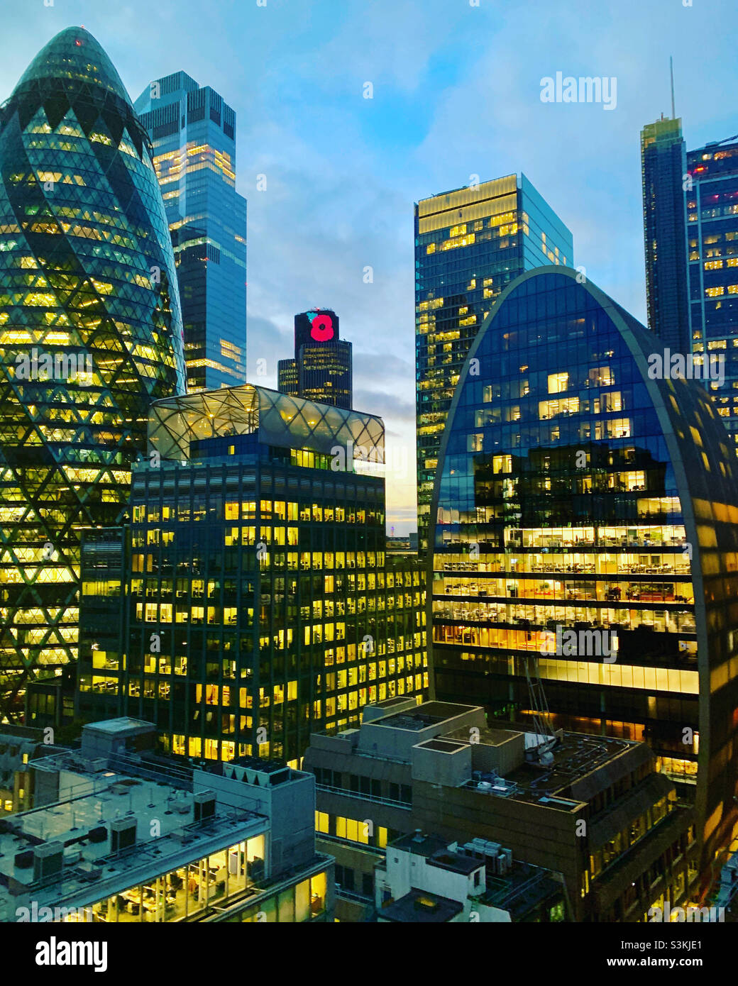View of buildings in London with lights on at sunset - Smartphone Captured Stock Image