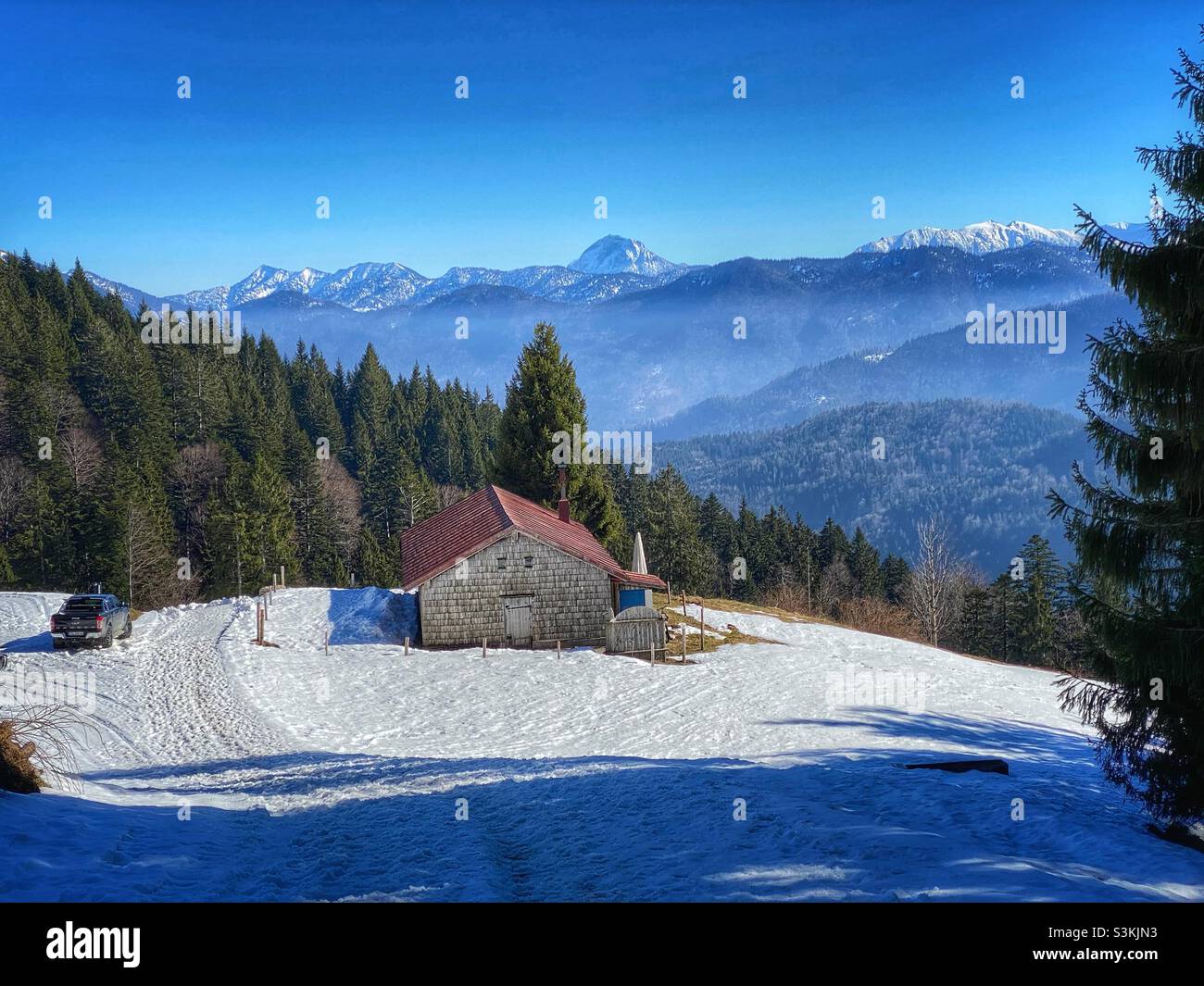 Alpine view with pine trees and snow from the top of Brauneck mountain in Bavarian Alps, Germany. - Smartphone Captured Stock Image
