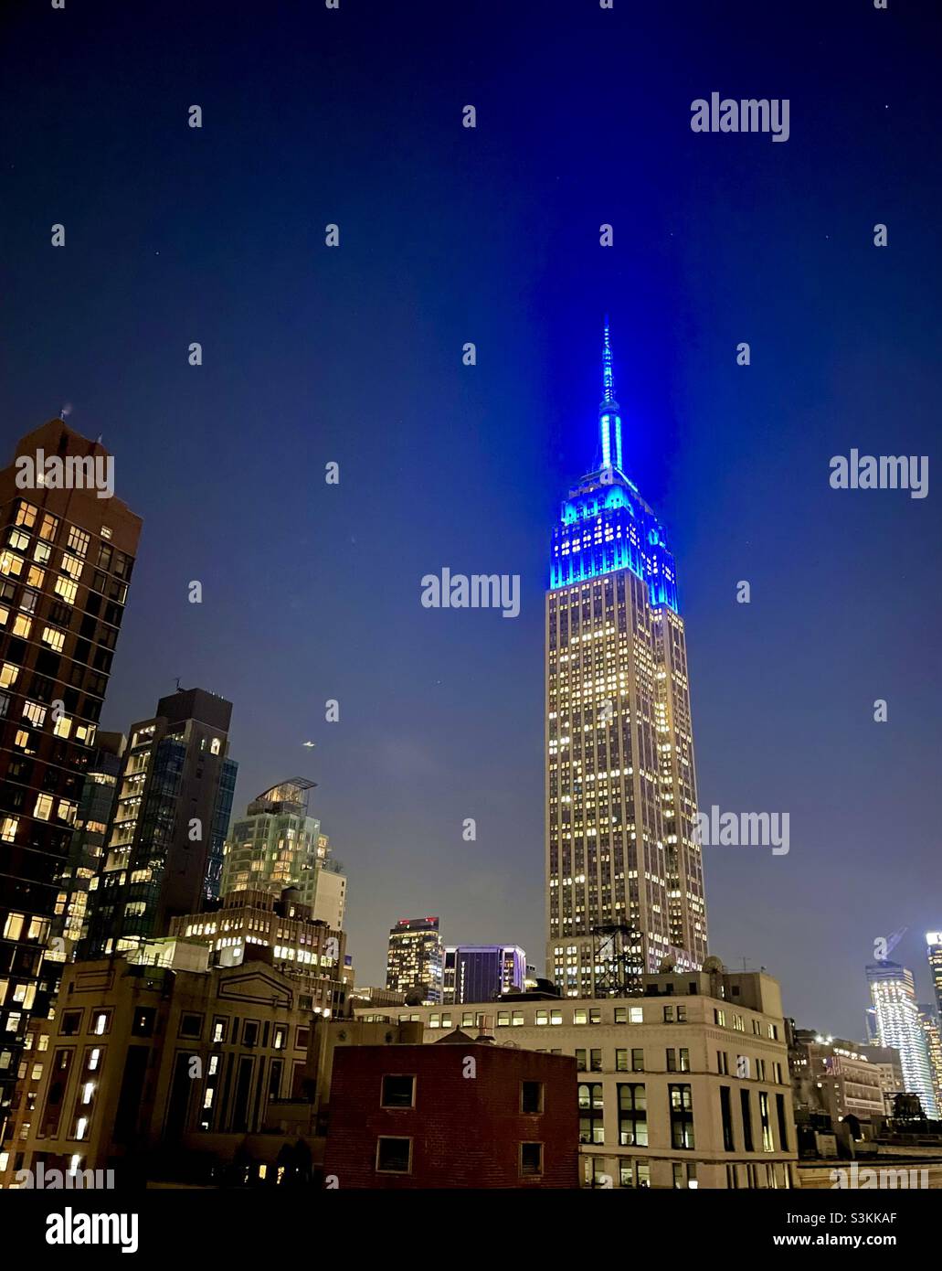 Blue lights atop the Empire State Building honoring 30 years of the Blue Man Group - Smartphone Captured Stock Image