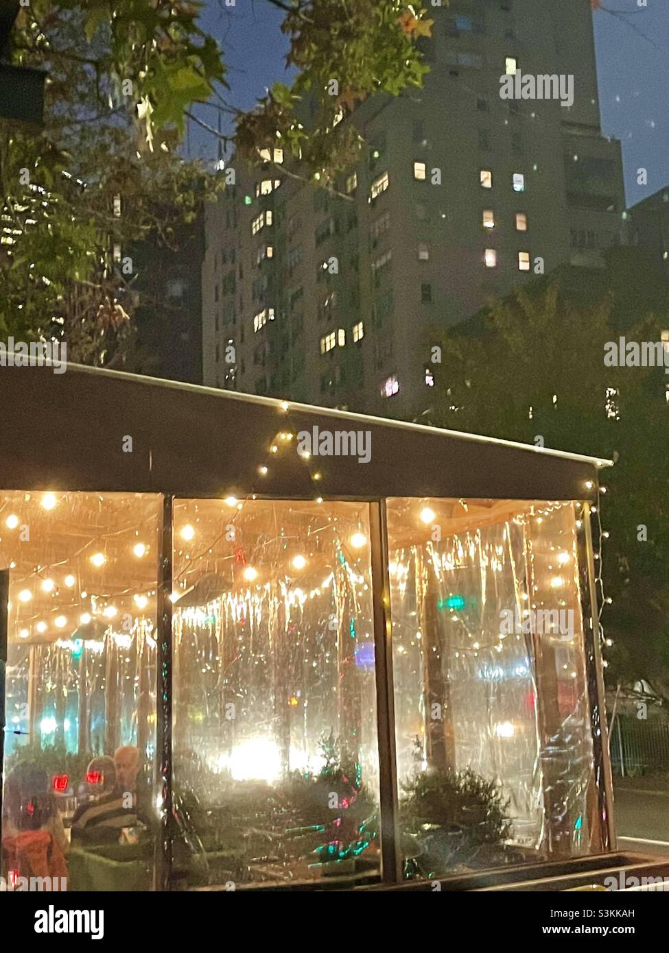 Sidewalk dining in New York City on an autumn evening - Smartphone Captured Stock Image