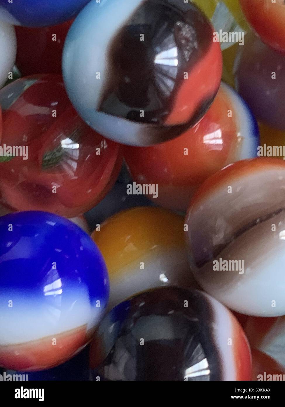 Close up of some old-style, nostalgic marbles, the kind I remember growing up and playing with as a kid. - Smartphone Captured Stock Image