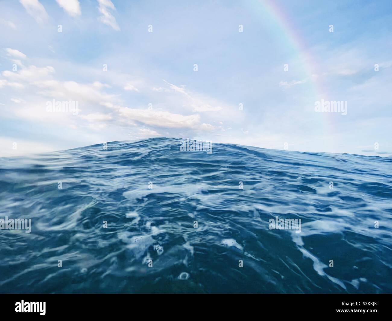 Rainbow over the ocean Stock Photo - Alamy