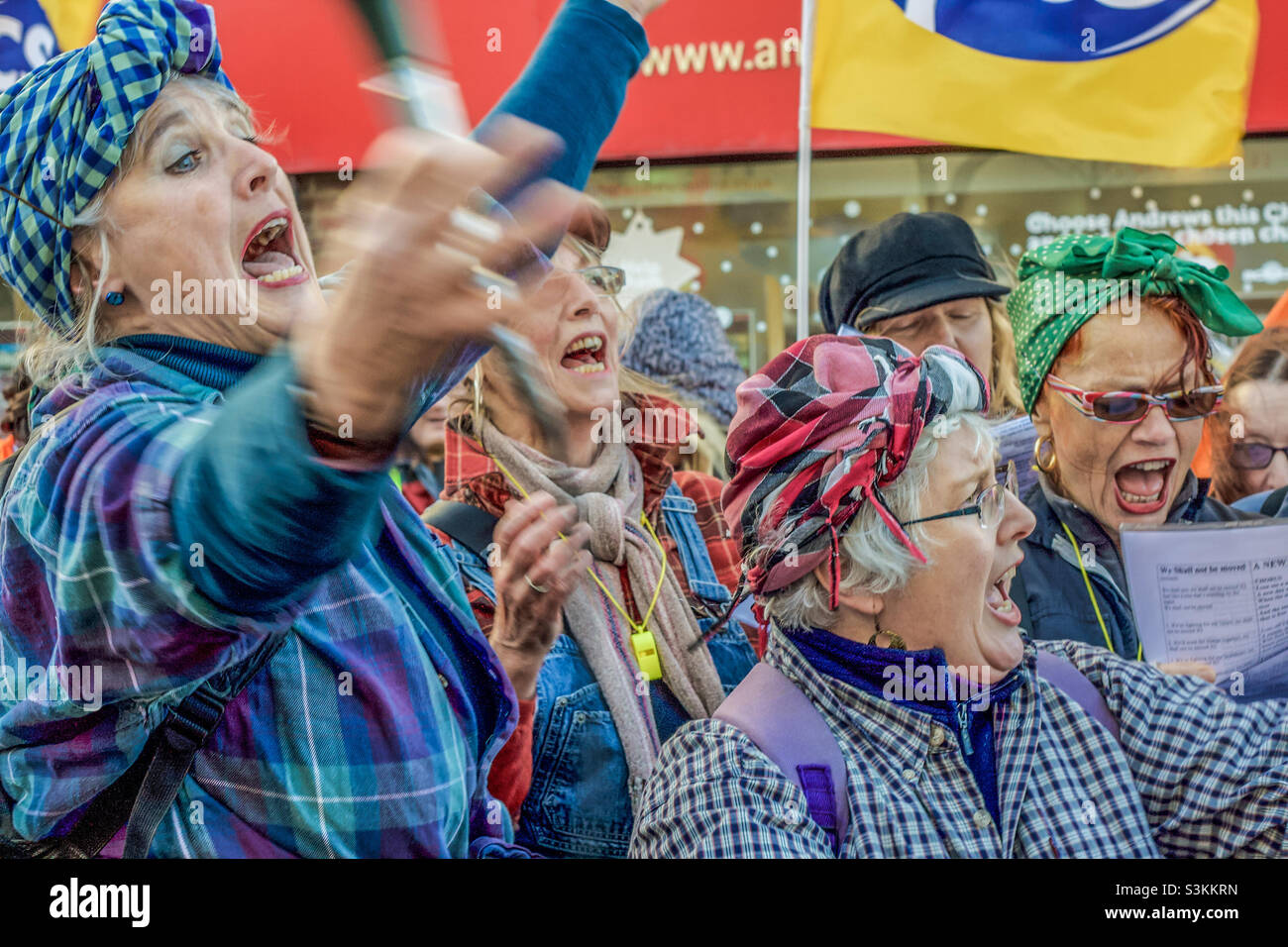 Women with scarves on their heads sing in rousing chorus at an anti-austerity demonstration in Hastings UK, November 2011 - Smartphone Captured Stock Image