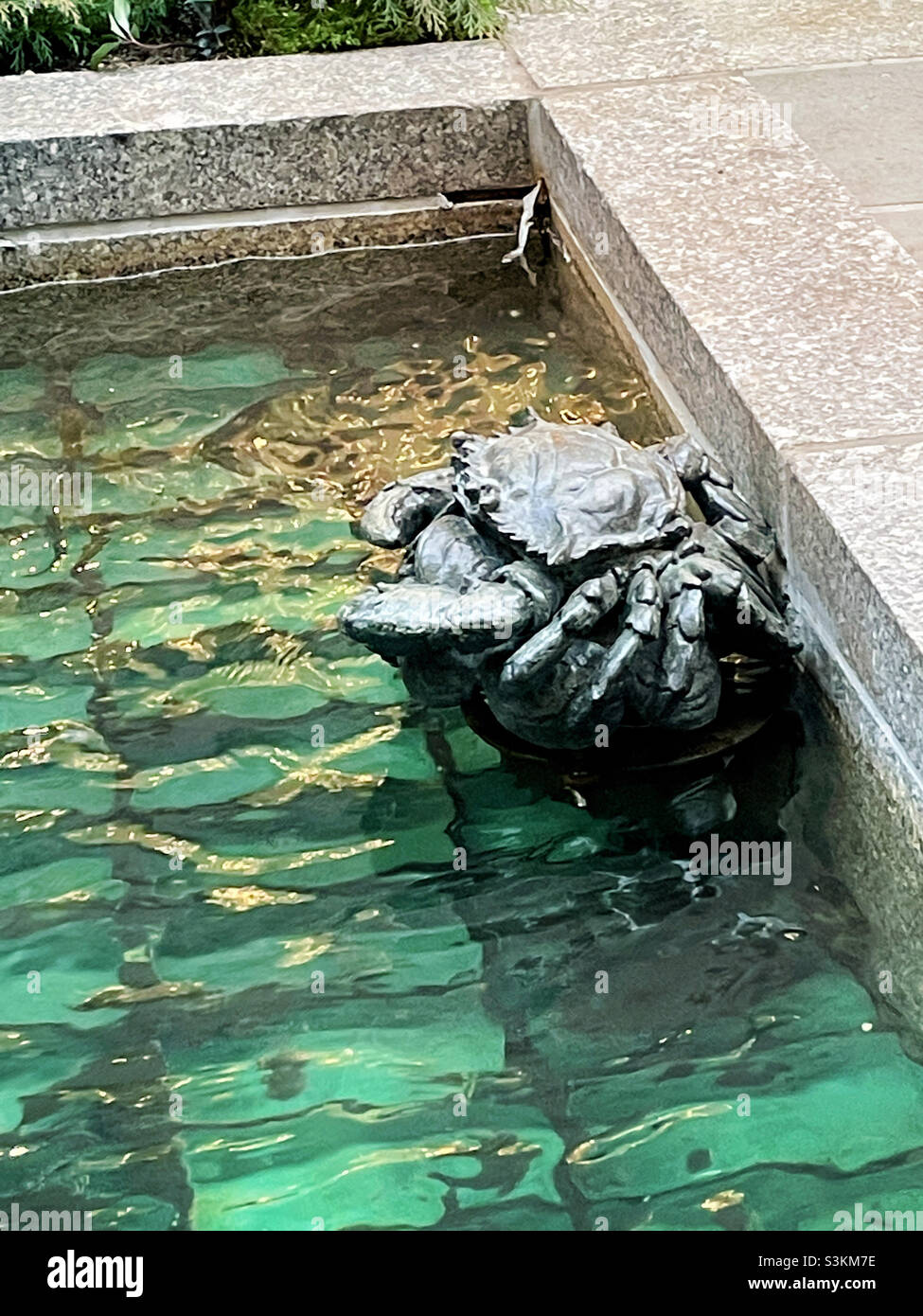 Close up of a crab statue in one of the fountains at Rockefeller Center channel Gardens, New York City, United States - Smartphone Captured Stock Image