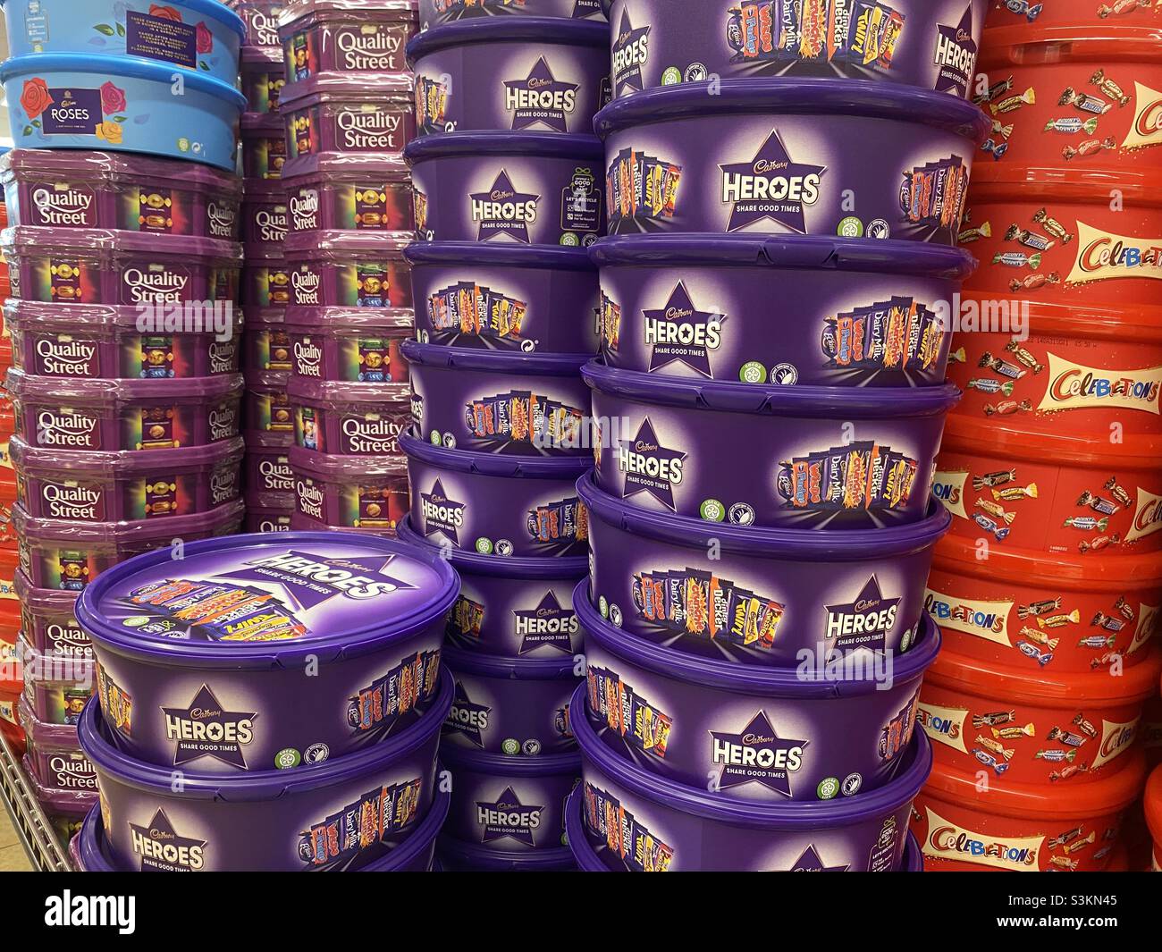 Stacks of tins of chocolate on a supermarket stall in readiness for the festive season. - Smartphone Captured Stock Image