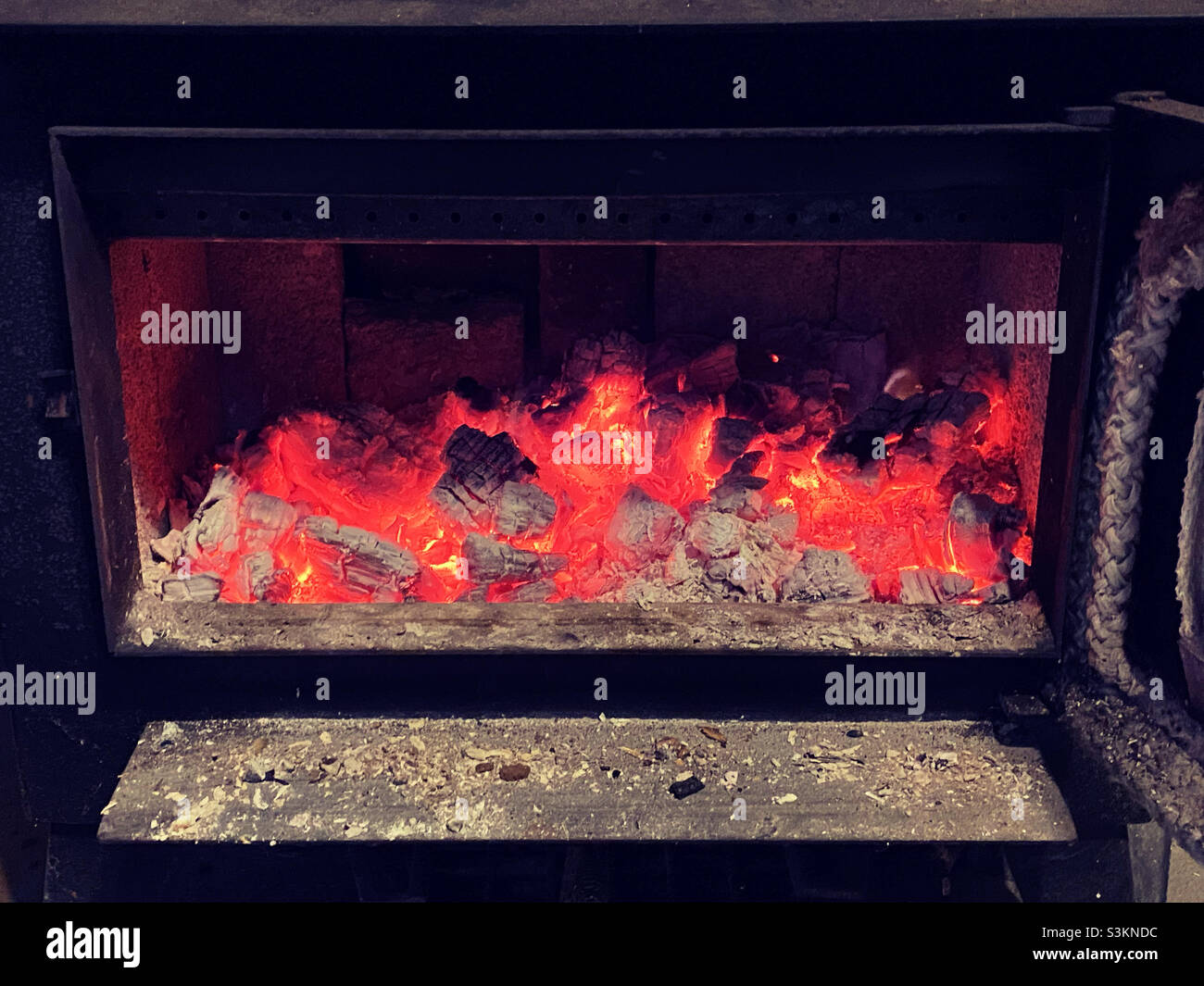 Glowing coals in wood stove - Smartphone Captured Stock Image