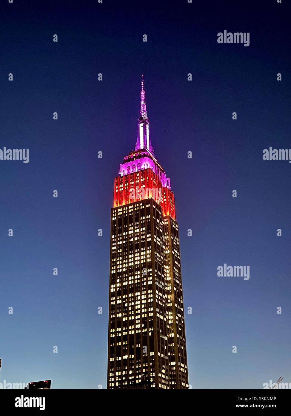Honoring Lupus Research Alliance with red & purple Tower lights on the Empire State Building - Smartphone Captured Stock Image