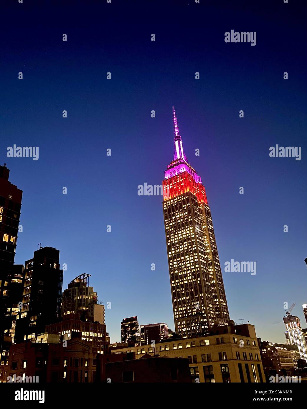 Red & purple Tower Lights on the Empire State Building honor theLupus Research Alliance - Smartphone Captured Stock Image