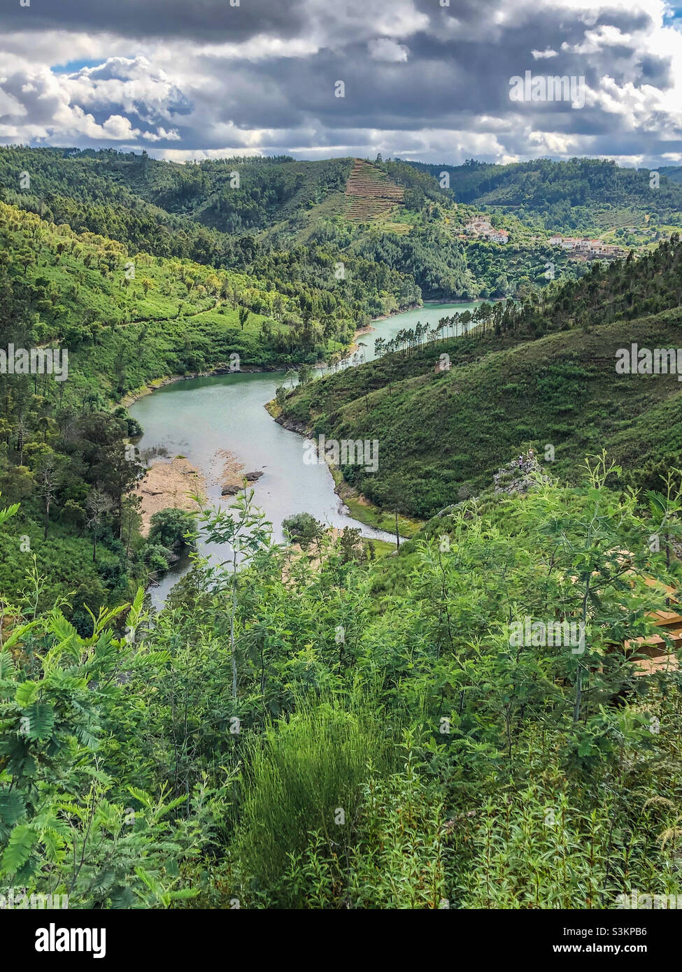 View of a green and luscious landscape, with a river running through the valley - Central Portugal - Smartphone Captured Stock Image