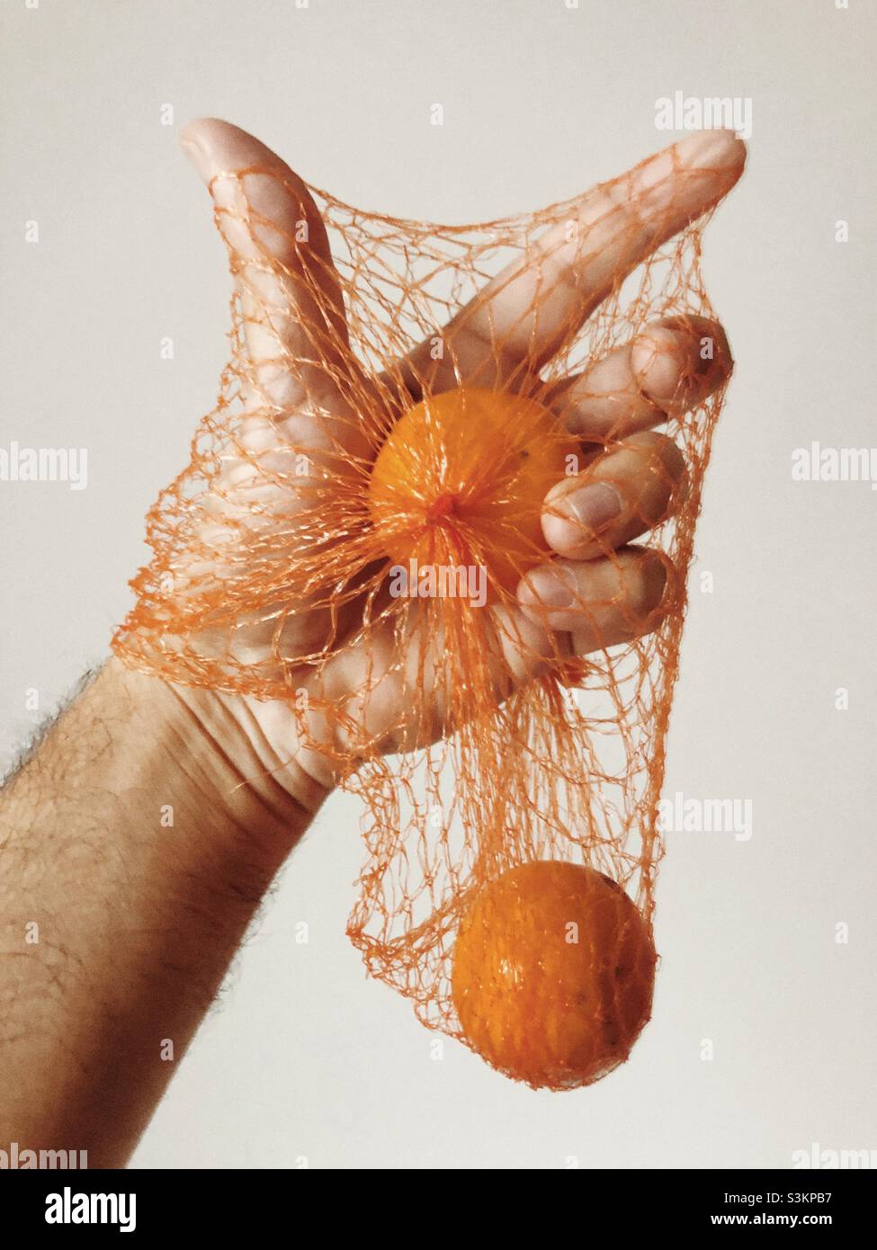 Tangerine in a mesh bag Stock Photo Alamy