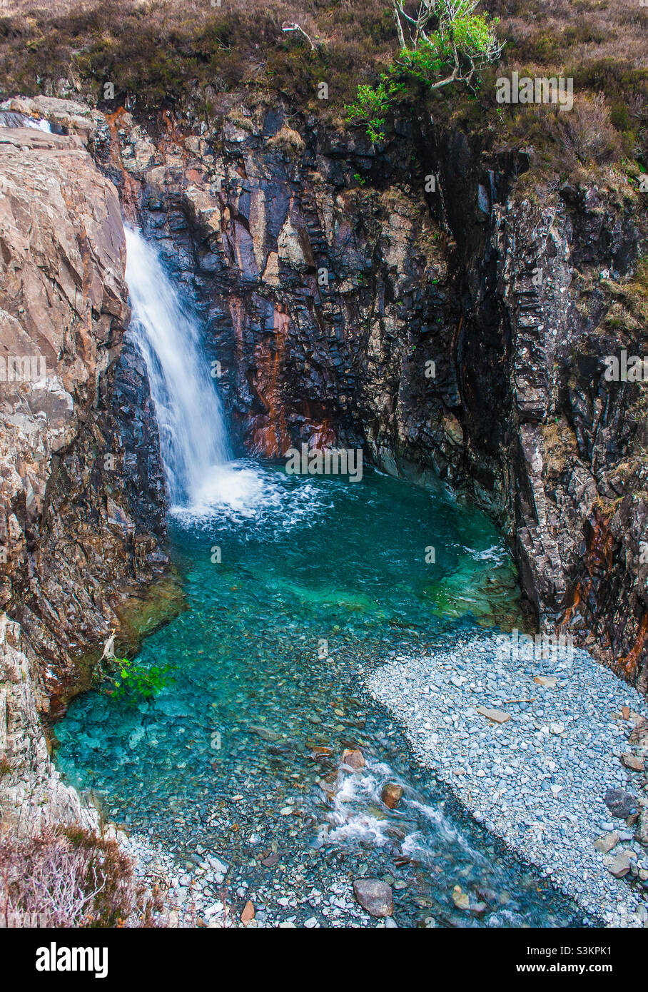 Cascades pour into the blue water of the fairy pools on the Isle of Skye, Scotland Stock Photo