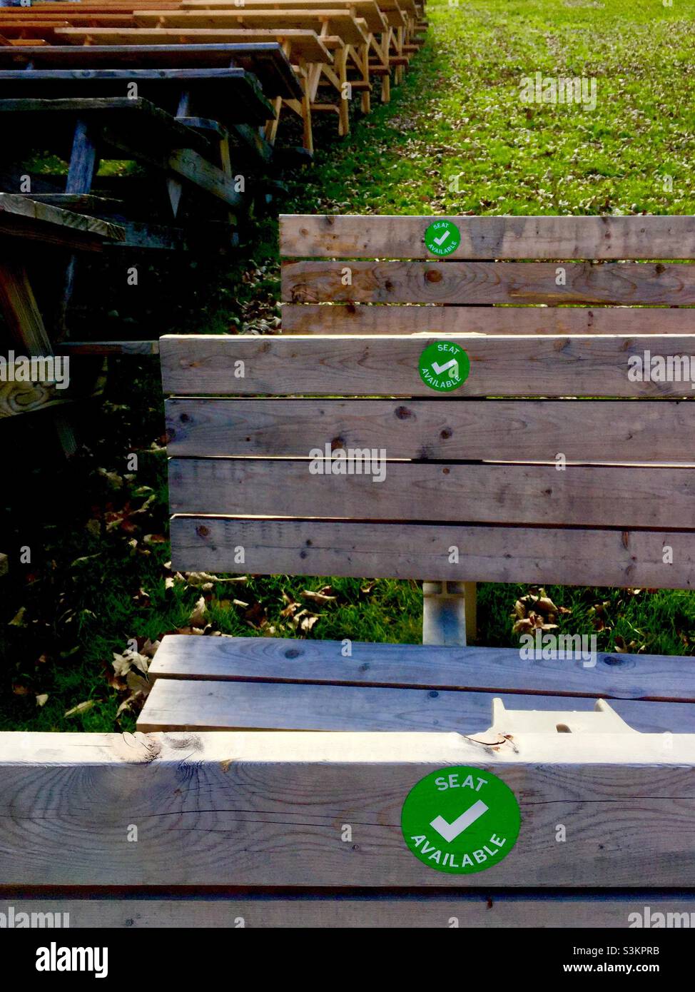 Socially distanced seating in a green space outdoors, Ontario, Canada. Covid protocol. Below capacity. Limited seating. - Smartphone Captured Stock Image