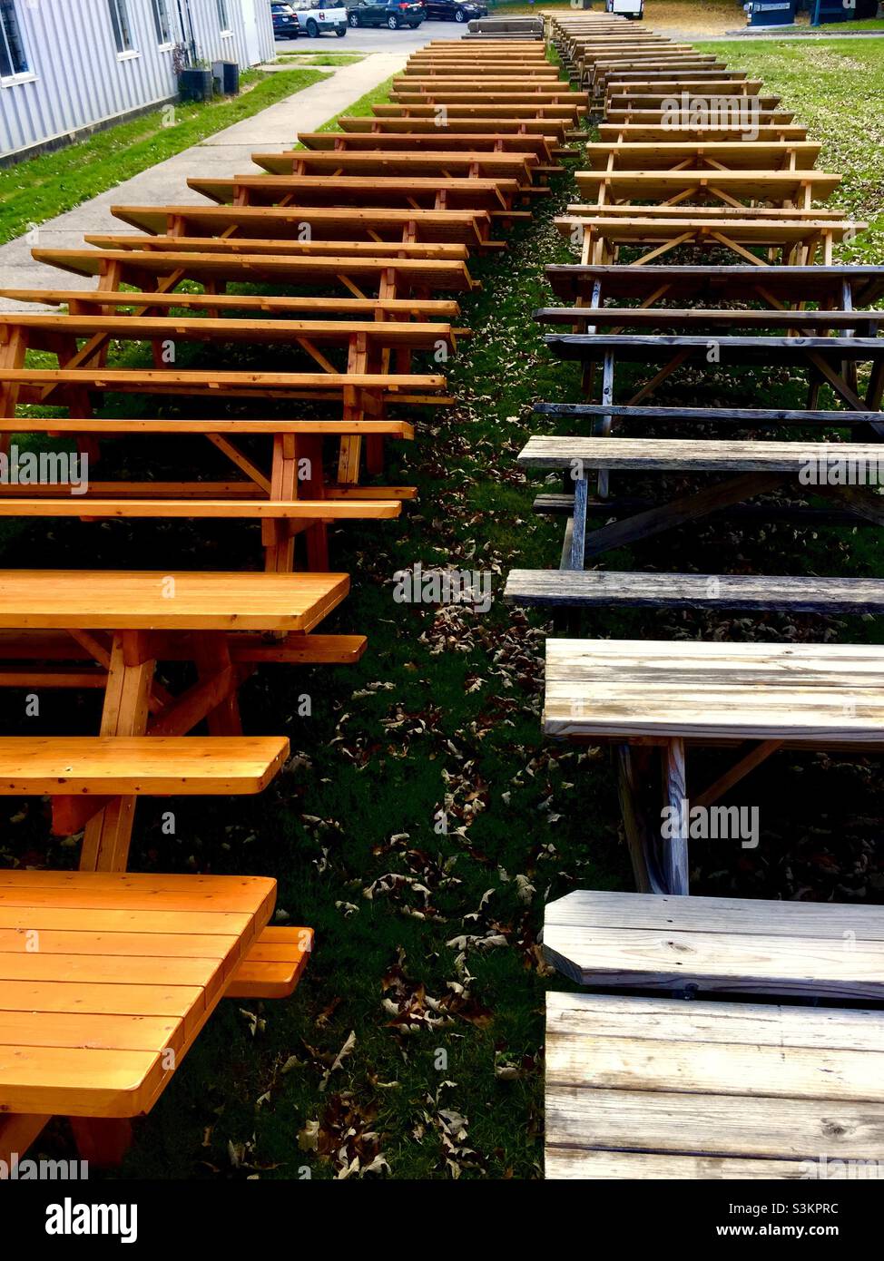 Outdoor picnic benches stacked in long rows for storage, Ontario, Canada. - Smartphone Captured Stock Image
